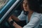 Close-up preety woman portrait holding hands on the steering whe