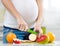 Close up pregnant woman cuts fruits