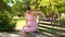 Close up of pregnant woman hands stroking belly on a Park bench in the summer