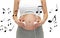 Close up of pregnant woman and headphones on tummy