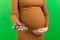 Close up of pregnant woman holding a pile of blisters of pills at colorful background with copy space. Vitamins during pregnancy