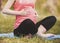 Close up. Pregnant Woman Practicing Yoga in Park.