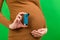 Close up of pregnant woman using asthma inhaler during attack for being healthy at colorful background with copy space. Health