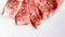 Close-up of Premium Rare Dry-Aged beef with high-marbled texture marinated with pepper and salt on white plate served for Yakiniku