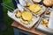 Close-up on the preparation of a great hamburger in the open air, the chef lays a cutlet, with potatoes.