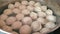 Close-up of preparing dumplings. In a saucepan of boiling water, delicious handmade dumplings are boiled and turned over. Homemade