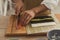 Close up preparing roll sushi at home. Male hands slicing ingredients salmon, cucumber, avocado and cream cheese