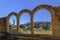 Close up of the preserved roman arches and the tower of the San Romolo Cathedral, Fiesole, Florence, Tuscany, Italy