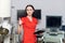 Close up of pretty Caucasian woman doctor standing in front of ultrasound and lithotripter machines and showing thumb up