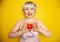 Close up pretty young woman holding an apple she`s about to eat