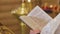 Close-up of the priest\'s hands with the prayer book. The Holy Father.