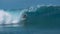 CLOSE UP: Pro extreme surfer rides a breathtaking emerald wave in sunny Tahiti.