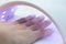 Close-up of the process of drying nails with gel polish in an ultraviolet lamp. Manicure in a beauty salon for female hands