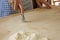 Close up process of homemade vegan farfalle pasta with durum wheat flour. The cook uses the rolling cutter to cut the dough,