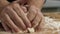 Close-up of professional Baker kneading dough. Stock footage. Giant hands of bakery chef knead dough with flour on