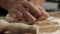 Close-up of professional Baker kneading dough. Stock footage. Giant hands of bakery chef knead dough with flour on