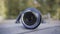 Close up of professional camera lens lying on a rotating children roundabout. Action. Photography concept. forgotten