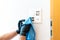 Close up of a professional cleaner cleaning a modern light switch and dimmer and socket