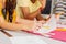 Close up of professional dressmakers holding sketches of clothes