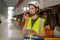 Close up professional engineer or technician worker woman hold tablet and use walkie talkie to communicate with other co-worker of