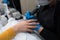 Close-up of professional Finger nail treatment, grinding and polishing with electric nail file drill. Mechanical beautician in bea