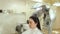 Close-up of professional hair dryer dries young girl`s hair in a beauty salon.