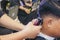 Close-up professional hairdresser using scissors and clippers and accessories for beautiful and decorating men hair Cutting hair