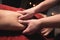 Close-up Professional sports hip massage. A male masseur massages a male athlete in a room with dimmed light against the