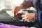 Close-up of a professional windshield repairman working with hydraulic polymer crack filler. Elimination of cracks and