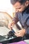 Close-up of a professional windshield repairman working with hydraulic polymer crack filler. Elimination of cracks and