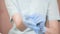 Close-up professional woman beautician puts on her hands blue rubber clean sterile gloves before doing the procedure for