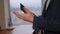 Close-up of the professor's hands with a tablet in the lecture hall