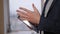 Close-up of the professor's hands with a tablet in the lecture hall.