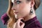 Close up profile portrait of beautiful woman choosing fashion jewelry