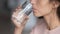 Close up profile thirsty woman drinking pure mineral water