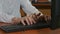 Close-up of programmer hands having a third hand typing