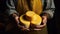 Close-up of a proud cheese maker exhibiting his cheese expertise. cheese in hands