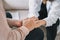 Close-up of psychiatrist hands together holding palm of her patient.  Psychological male comforting and holding a woman hand while