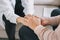 Close-up of psychiatrist hands together holding palm of her patient.  Psychological male comforting and holding a woman hand while