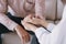 Close-up of psychiatrist hands together holding palm of her patient.  Psychological women comforting and holding a male hand while