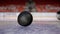 Close-up of puck falling on ice. Action. Puck slowly and epically falls to ice. Mesmerizing puck drop before impact