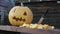 Close-up of a pumpkin and a lantern Jack lying on the table, next to cutting vegetables. Next to the knife sticks with a