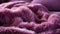 A close up of a purple blanket background