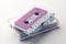 Close up of purple cassette tape and white box on white background