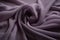 a close up of a purple fabric with very thin lines on it\\\'s edges and a very soft, wrinkled fabric in the middle