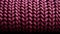 A close up of a purple knitted fabric