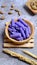 Close up, purple raspberry, Wafer roll stick on a wooden bowl.