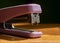 Close up of a purple stapler on wooden table