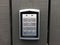 Close up push button lock. Security code door lock on grey wooden panels.