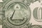 Close up of the pyramid and eye on the back of a one dollar bill